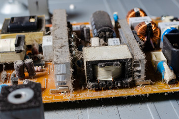 A thick layer of dust covers the internal electronic components of the computer