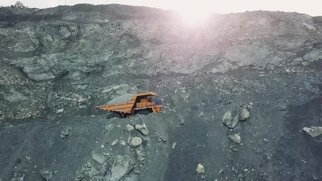 Large dump truck carries chalk ore in the quarry. Mining industry.