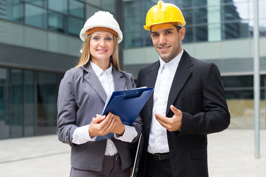 Portrait of smiling architectors who standing with folder
