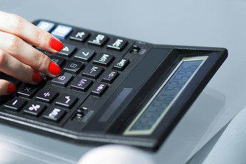 .closeup.business woman using a calculator at the workplace.