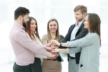 portrait of confident business team stacking hands