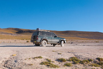 Fototapeta na wymiar Offroad car in desert in the South of Bolivia
