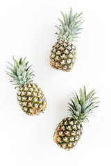 Fototapeta premium Pineapples isolated on white background. Food concept. Flat lay, top view