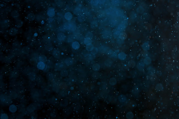 Color glitter on dark background. Bokeh effect
