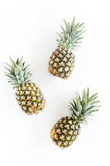 Fototapeta premium Pineapples isolated on white background. Food concept. Flat lay, top view