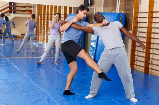 Two men practicing self defense techniques