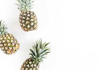 Obraz premium Pineapples isolated on white background. Food concept. Flat lay, top view