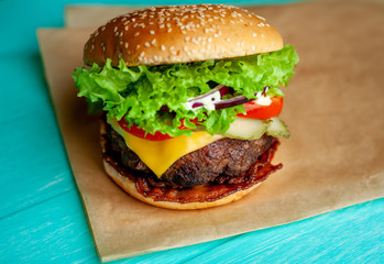 mouth-watering delicious homemade burger used to chop beef on the wooden table