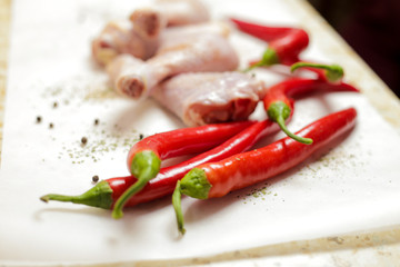 raw chicken with red peppers and spices 