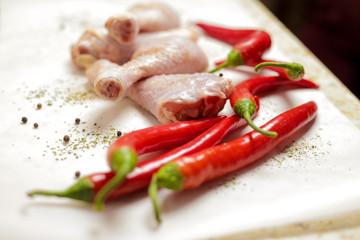 raw chicken with red peppers and spices 