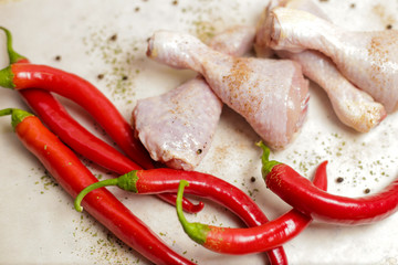 raw chicken with red peppers and spices 