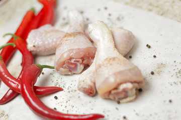raw chicken with red peppers and spices 
