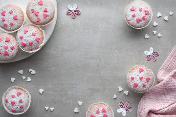 Sugar-sprinkled muffins with pink and white fondant icing hearts
