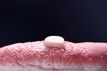 Hot bun with sesame for hot dogs. Melted butter.