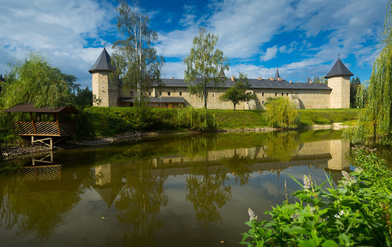 Sucevita monastery across pond, Romania