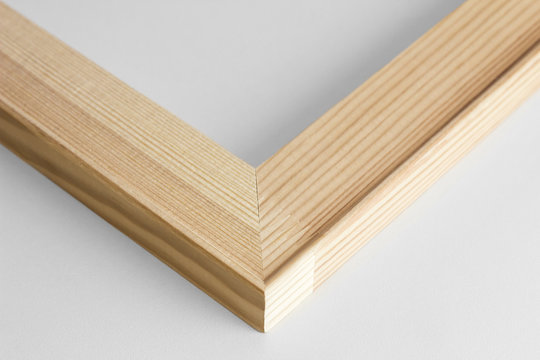 Corner of wooden subframe on gray background.