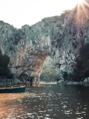 Natural Bridge Pont d'Arc and canoe in Southern France