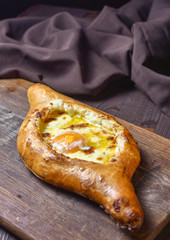 Ajarian traditional flatbread - khachapuri or hachapuri with egg and cheese. Copy text area for menu design or recipe book text.