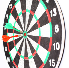 dart Board with a dart in the center of the target