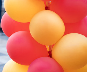 Detail of a row of red and yellow balloons with a side view