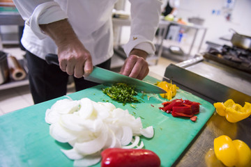 Chef hands cutting fresh and delicious vegetables