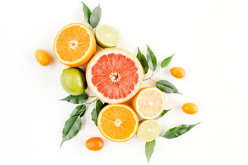 Creative layout made of summer tropical fruits: grapefruit, orange, lemon, lime and leaves ficus. Food concept. flat lay, top view
