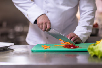 Chef hands cutting fresh and delicious vegetables