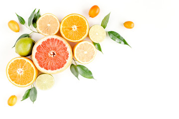 Creative layout made of summer tropical fruits: grapefruit, orange, lemon, lime and leaves ficus. Food concept. flat lay, top view