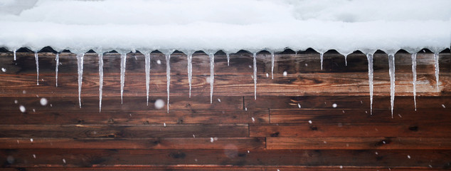 Snowy background with icicles and snowflackes