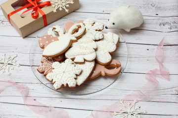 Christmas gingerbread cookies on light wooden background
