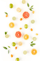 Creative pattern made of summer tropical fruits: grapefruit, orange, lemon, lime and leaves ficus. Food concept.  flat lay, top view