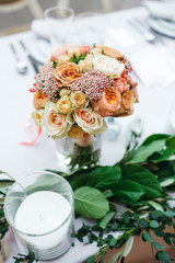 Dinner table serving. Violet and beige tones, pastel colors. Beautiful decoration of wedding banquet in restaurant with glasses, plates, forks and knives, white tablecloth.
