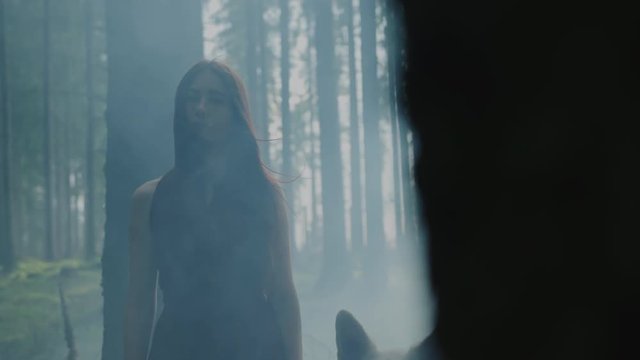 Woman in a misty forest