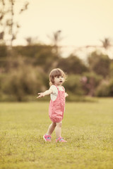 little girl spending time at backyard