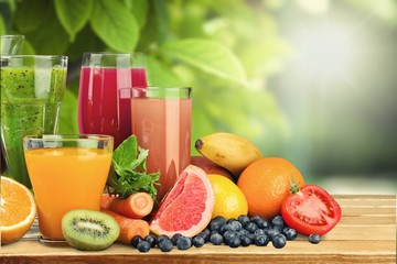 Tasty fruits  and juice with vitamins on background