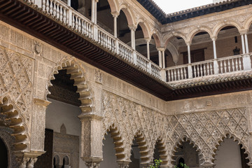 Fototapeta premium Beautiful architecture of the famous Alcazar of Seville Royal Palace. It is one of the most famous historical palaces in Spain and boasts of the finest architectural beauty.