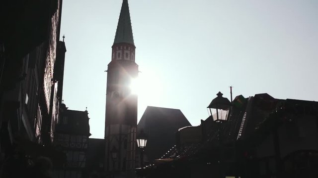 Old St. Nicholas Church Tower and Frankfurt Christmas Market Backlit by Sunlight