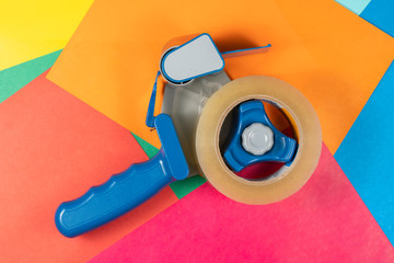 Adhesive tape roll isolated on colorful background