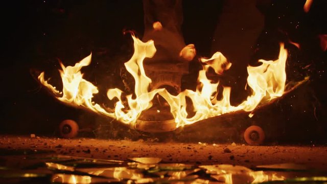Breaking a flaming skateboard