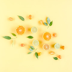 Creative background made of summer tropical fruits: grapefruit, orange, lemon, lime and leaves ficus. Food concept. flat lay, top view