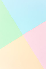 Background pastel colors: pink, yellow, blue, green. Geometric pattern papers. Minimal concept. Flat lay, Top view. 