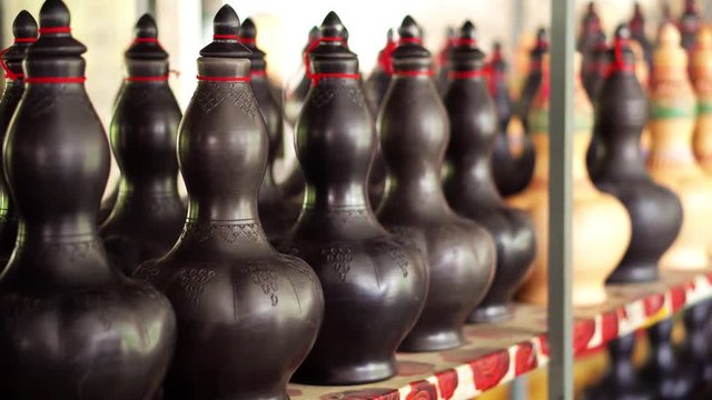 Handmade traditional craft known as 'labu sayong' normally used as gift or souvenir found in Perak,Malaysia. Clay pottery arts. Artistic clay container carving. GRADED.Panning Shot