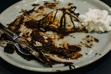 chocolate pancakes with cream, finished meal