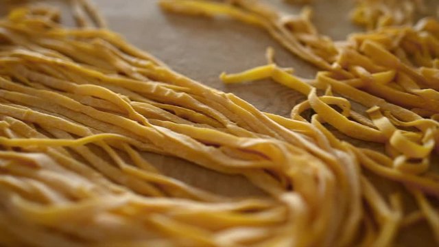 Fresh pasta called 'Fettuccine' made from fresh eggs and durum wheat flour. Fettuccine is a flat thick pasta popular in Roman and Tuscan cuisine.