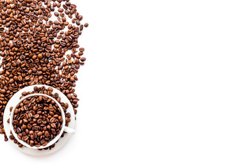 Coffee concept. Roasted beans on white background top view copy space