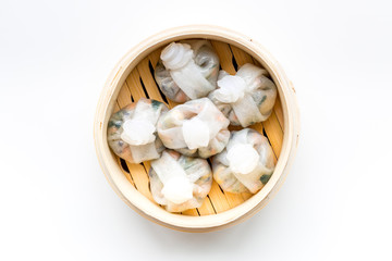 Dinner in Chinese restaurant with dim sum on white background top view