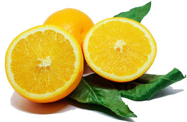 Two halves of cut orange and one tangerine on green leaves on white background