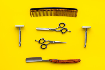 barber workspace in barbershop with equipment yellow background top view