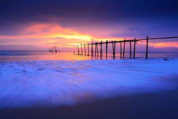 Fototapeta na wymiar Seascape of Jetty wooden in Pilai beach, Phang-Nga, Thailand. Beautiful of seascape at sunset in sea southern of Thailand, 