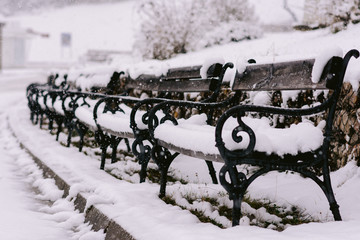a group of benches in the snow